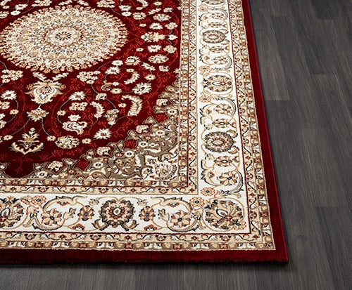 Vloerkleed Dubai Deluxe 56253 Rood – Geweven met Jute Rugzijde – opgerolde hoek op een houten vloer