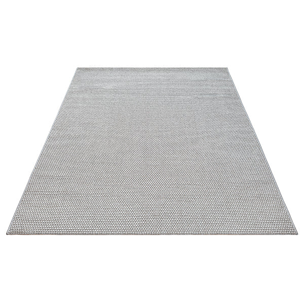 Vloerkleed Mira 7506 Grijs – Laagpolig met Pool van 6 mm – opgerolde hoek op een houten vloer