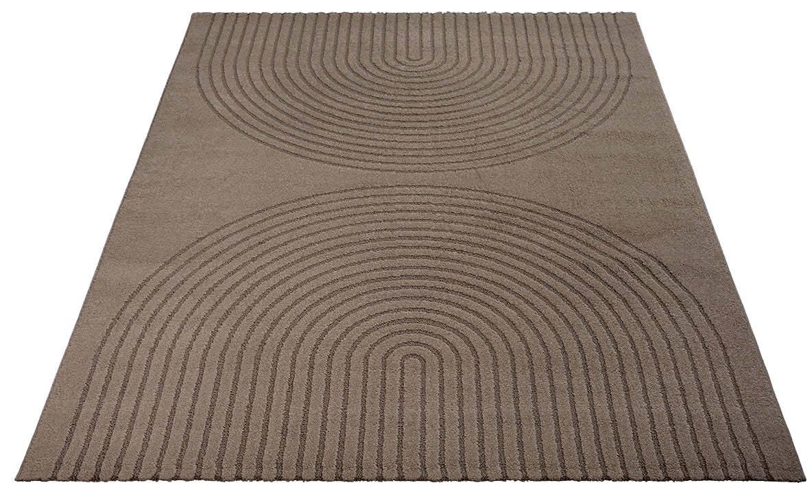 Vloerkleed Eclipse 2320 Bruin – Grafische cirkels op jute rug – opgerolde hoek op houten vloer